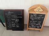 two chalk boards that are sitting next to each other