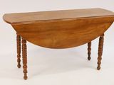 an old wooden table with turned legs on a white background