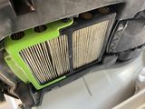 a green and black air filter in the back of a car