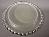 a glass plate with a beaded edge on a table