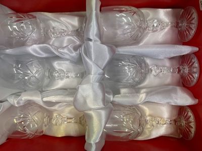 six empty wine glasses in a red box with a ribbon