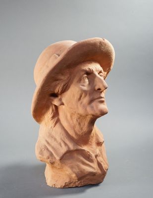 statue of a man with a hat on his head wearing a hat