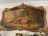 a painting on the wall above a mirror in a room