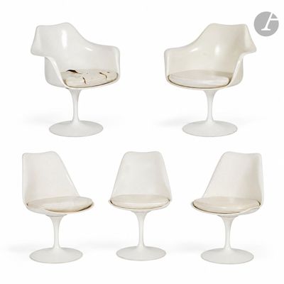 quatre chaises « Tulip » blanches et une chaise avec un coussin