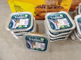 several containers of yarrah dog food sitting on a table next to a bag of dog food
