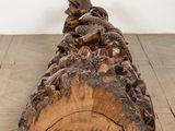 a wooden log with carvings on it on the floor