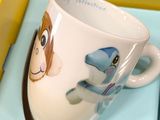 a coffee cup with a picture of a dog on it