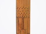 a wooden object with holes on it on a white surface