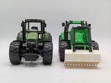 two toy tractors that are sitting next to each other