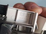 a person holding a small metal object in their hand