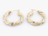 two tone twisted hoop earrings on a white background