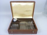 a wooden box with silverware in it on a white surface