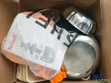 a cardboard box with a couple of pots and pans inside of it