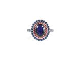 an image of a ring with a blue stone surrounded by blue and red stones