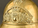 a gold helmet with a crest and shield on it
