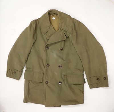 an image of a green jacket with buttons on the collar