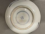 a white plate with a blue and white design on it