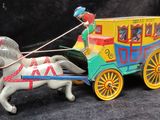 a toy horse pulling a carriage with a man on it