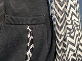 the back of a black and white sweater with a black and white pattern on it