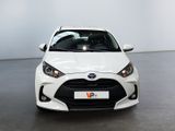 a white toyota yaris parked in a large room
