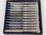 a lot of silverware in a case on a table