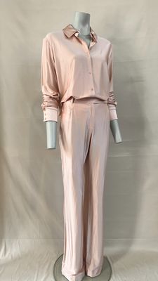pink silk pajamas and pants on a mannequin base