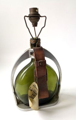 a green glass bottle with a tag on it