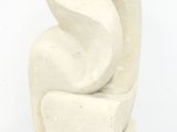 a white sculpture of a bird sitting on top of a table