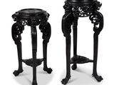 pair of black carved stools with legs and feet