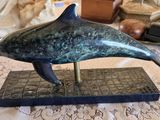 statue of a dolphin on a marble base on a table