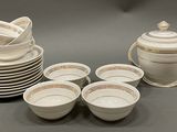 many cups and saucers sitting on the table