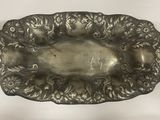 an antique silver plate on a white table with a black and white background