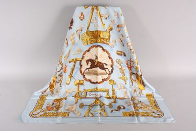 an image of a blue and gold scarf with a horse on it