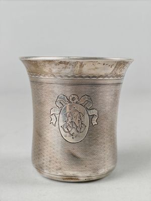 an antique silver cup with a lion emblem on the side