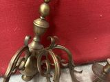 pair of antique brass candlesticks on a red background