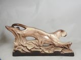 statue of a dog on a branch with leaves on a white background