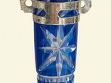 a blue glass vase with a star design on it