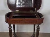 an old wooden table with a mirror on top of it