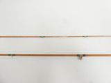 two wooden fishing rods on a white background