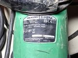 a close up of a green and black machine on a table