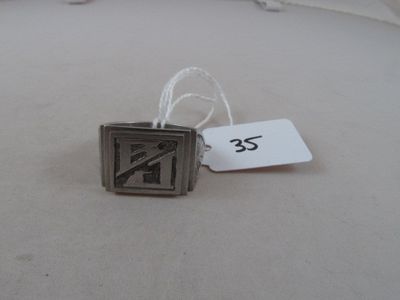 a silver ring with a no smoking sign on it