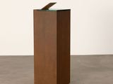 an image of a sculpture of a piece of wood with a piece of glass on top of it