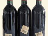 three bottles of wine that are sitting on a table