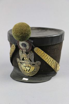 a black hat with a green pom pom on it