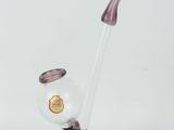 purple glass vase with a curved handle and a clear glass vase with a red handle