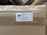 a cardboard box with a sticker on it sitting in a pile of other boxes