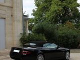a black sports car parked in front of a house