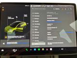 a laptop with a car on the screen on a table