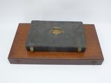 a black suitcase sitting on top of a wooden box