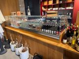 many bottles of wine on the counter in the store
